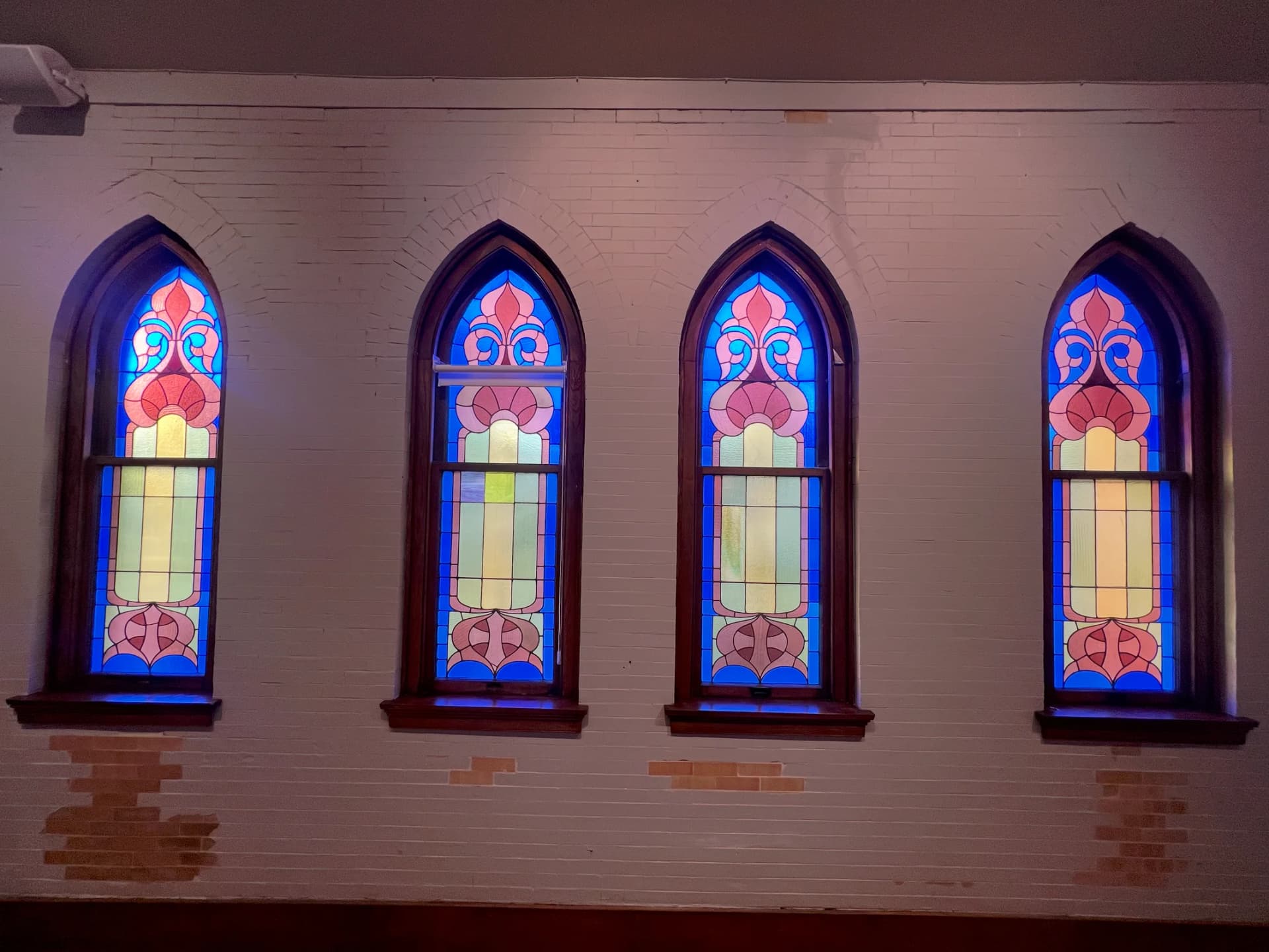 Gathering beneath century-old stained glass