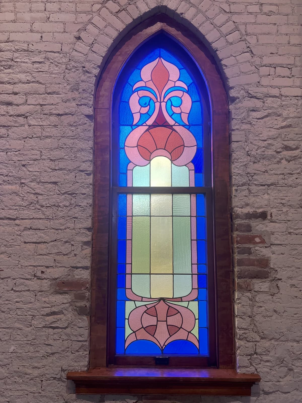 Original 1905 windows fill the space with sacred light