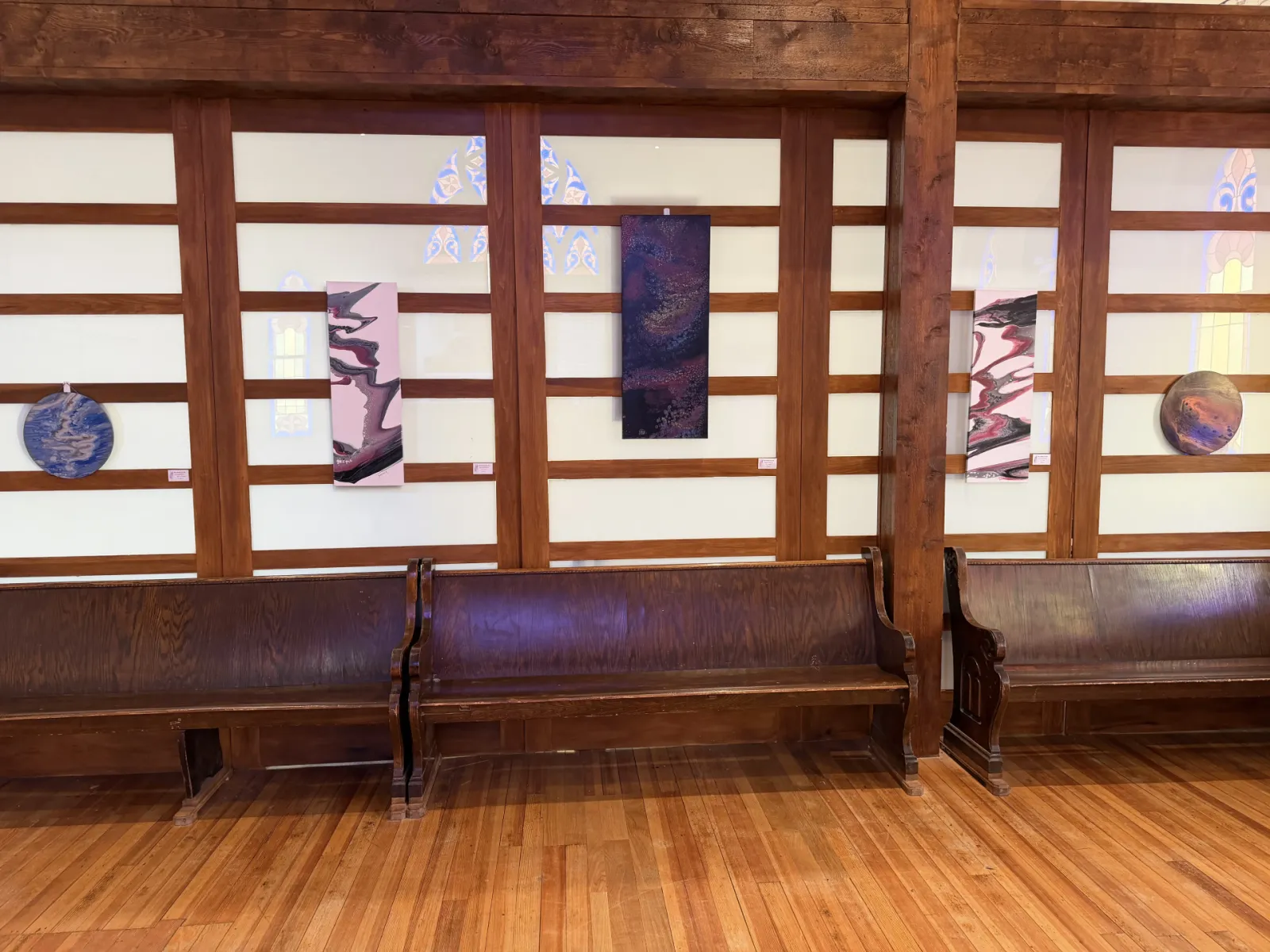 Work by resident artist Karen Borthick, hung above the original pews