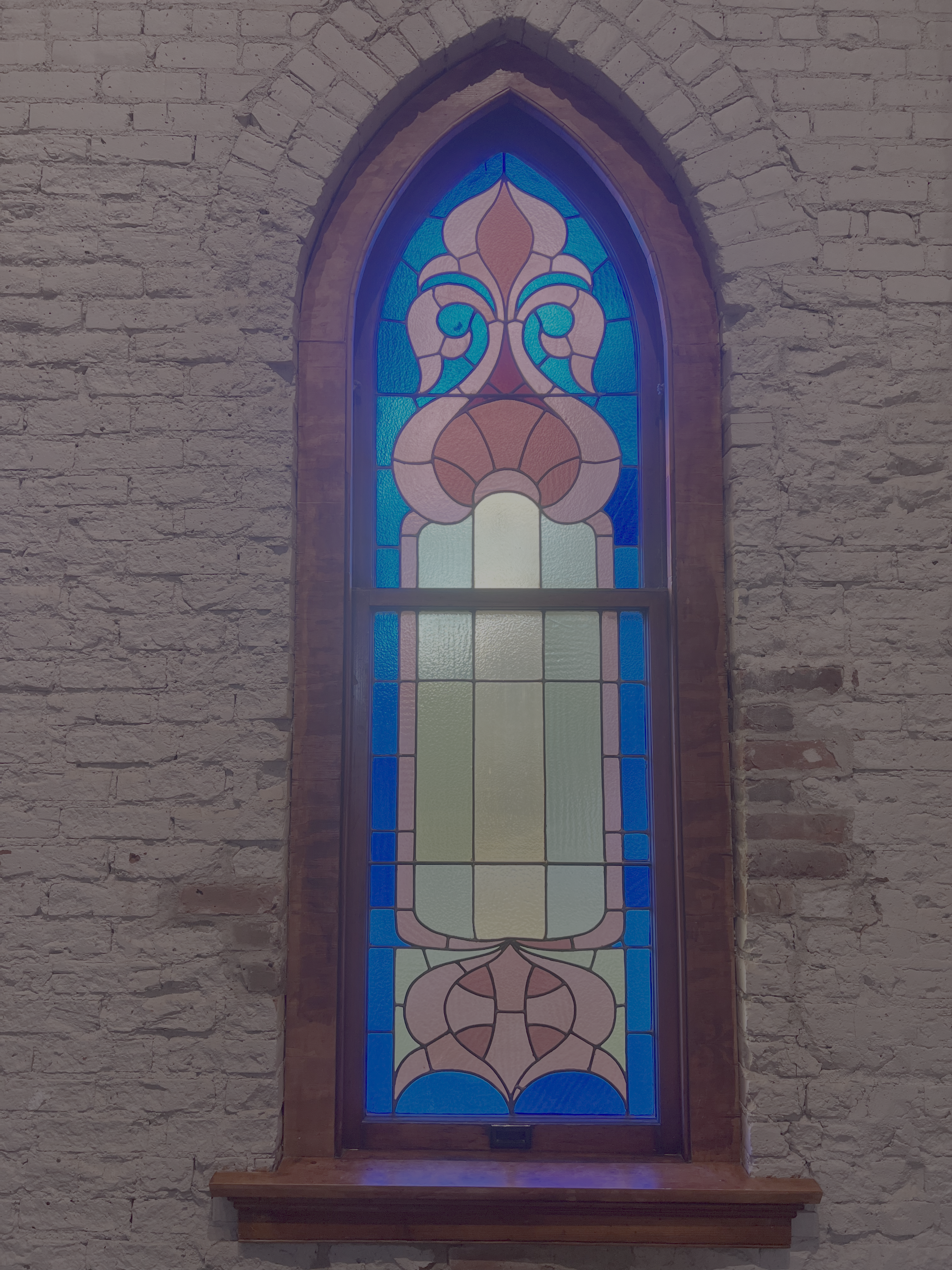 Original 1905 windows fill the space with sacred light
