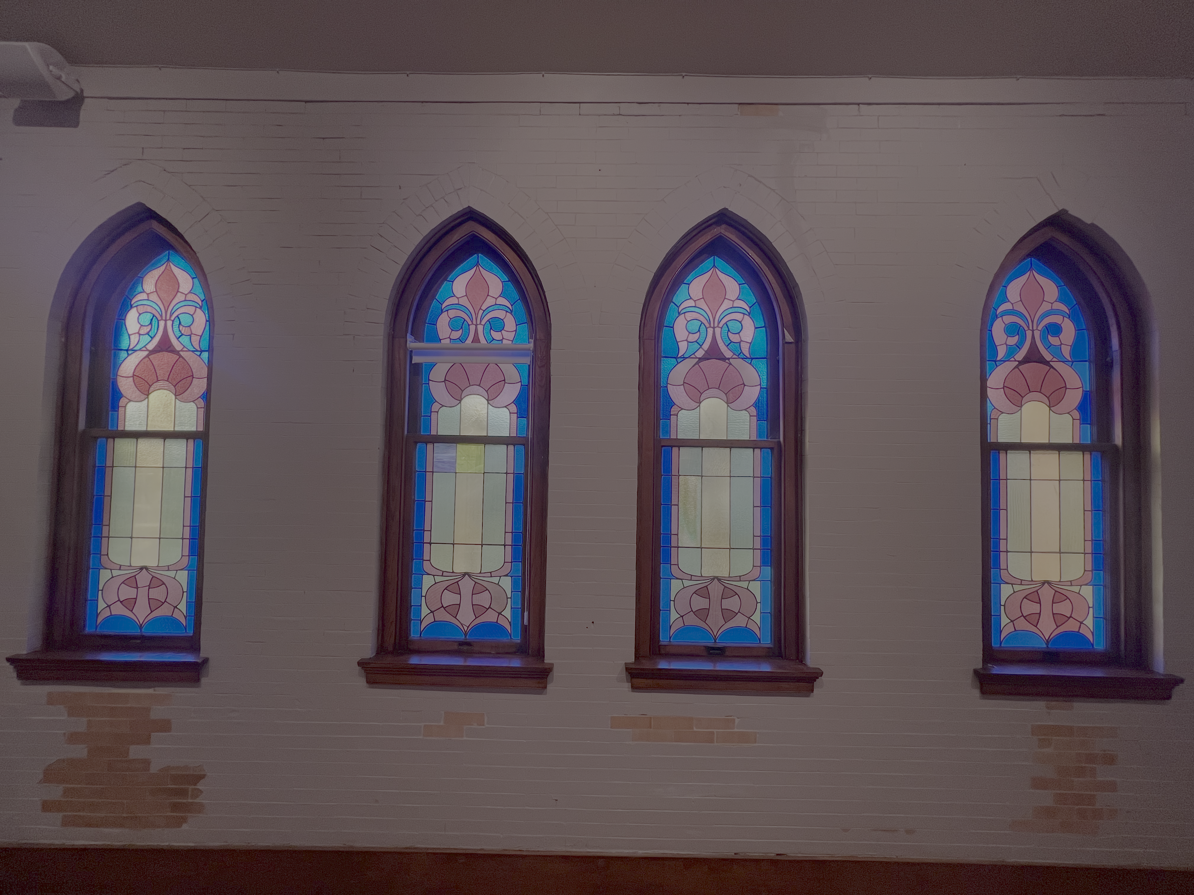 Gathering beneath century-old stained glass